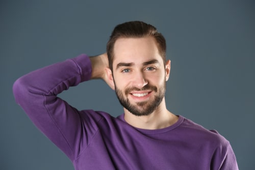 Portrait,Of,Young,Man,With,Beautiful,Hair,On,Grey,Background